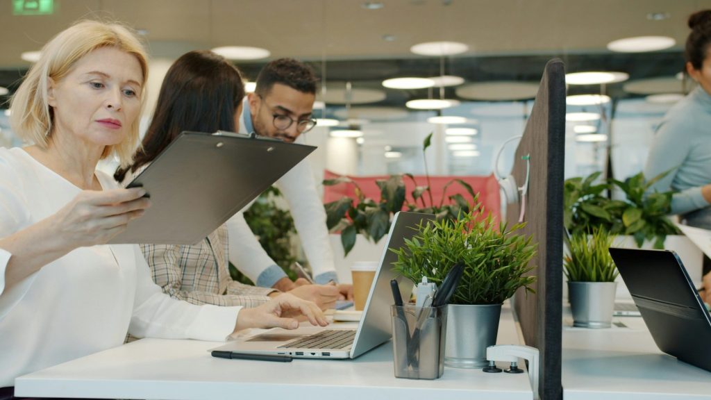 Colleagues collaborating in a modern office environment.
